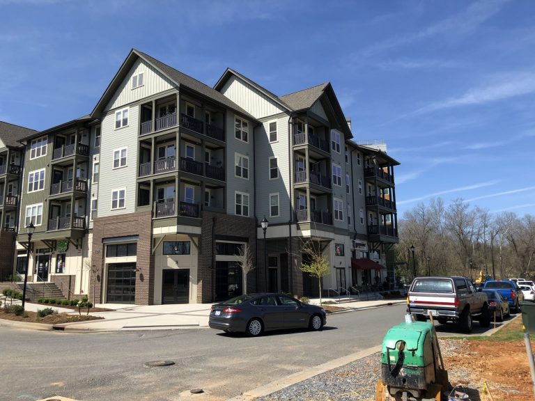 A newly built mixed-use building at the Riverwalk community catches the late-day sun where the Carolina Thread Trail meets a thriving Rock Hill neighborhood.