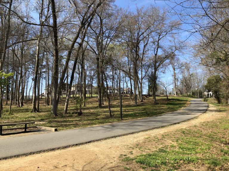 A quiet stretch of the Carolina Thread Trail glides past bare hardwoods and distant homes, offering walkers a peaceful escape just minutes from town.