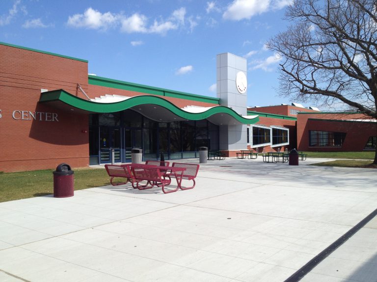 The Campus Center plaza, clock tower, and signature green canopy at SUNY Farmingdale.