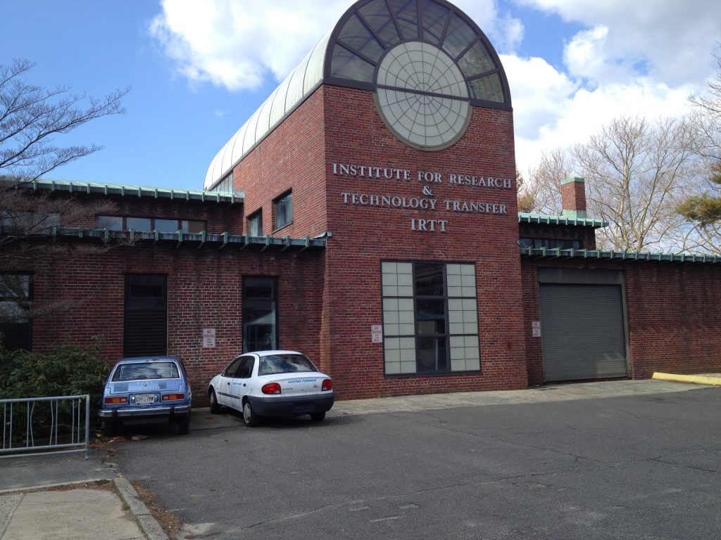 Brick building topped with a barrel-vaulted oculus skylight reading INSTITUTE FOR RESEARCH AND TECHNOLOGY TRANSFER IRTT.