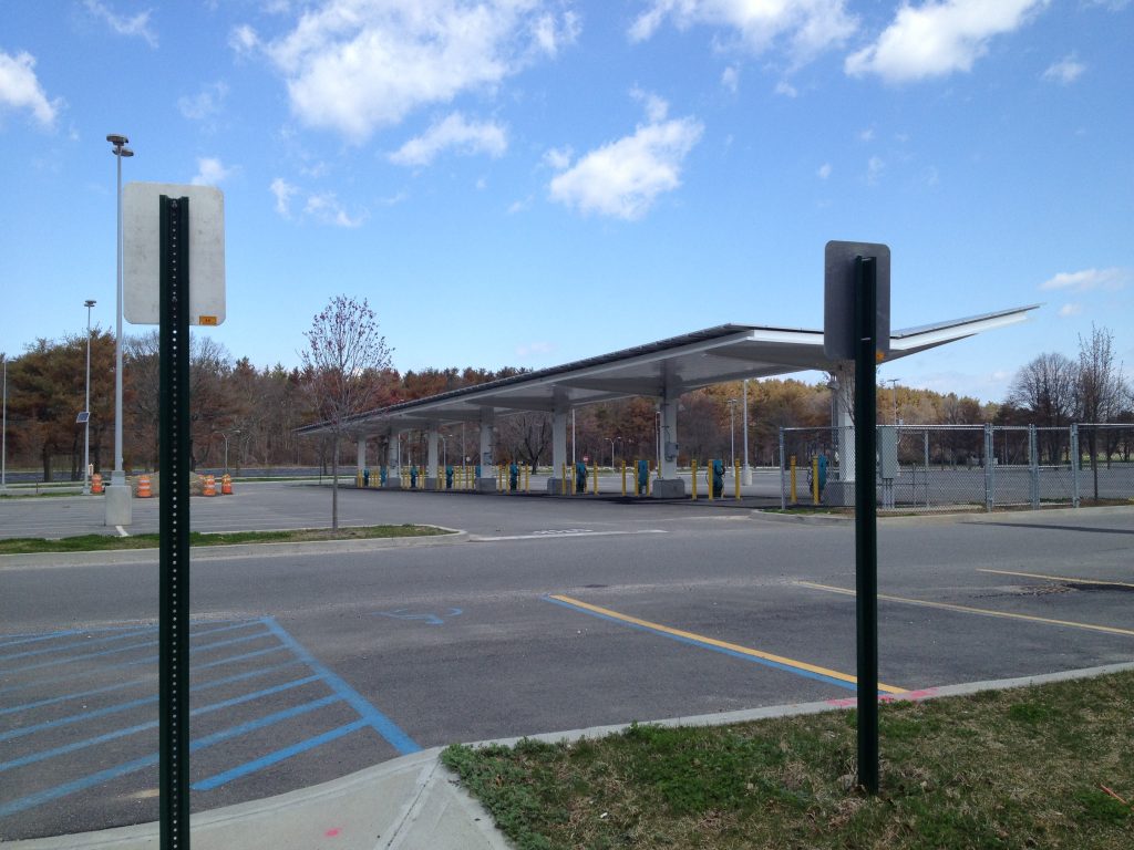 SUNY Farmingdale campus canopy structure overlooking an empty parking lot under a partly cloudy sky, April 2013.