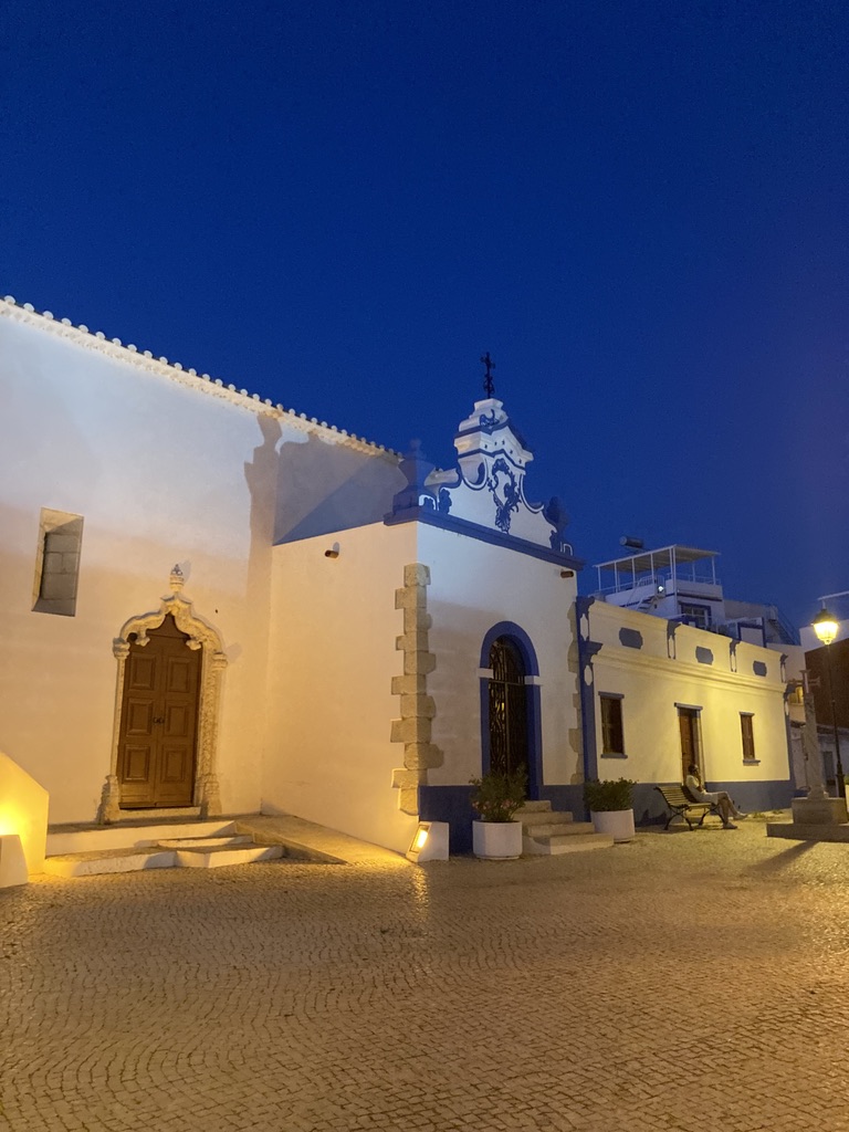 A village chapel glowing into the night