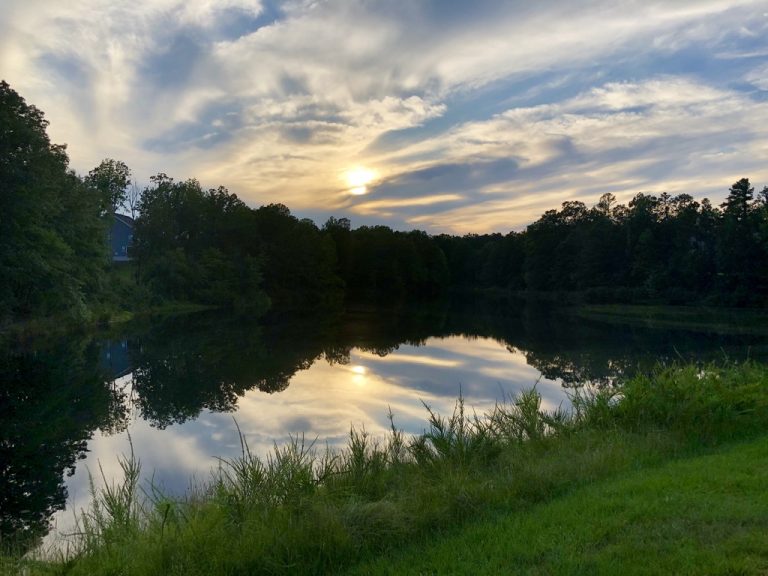 Sunset clouds mirrored across the still surface of Lake Wylie.
