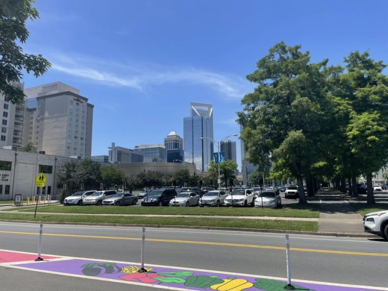 Public art at the corner with uptown beyond