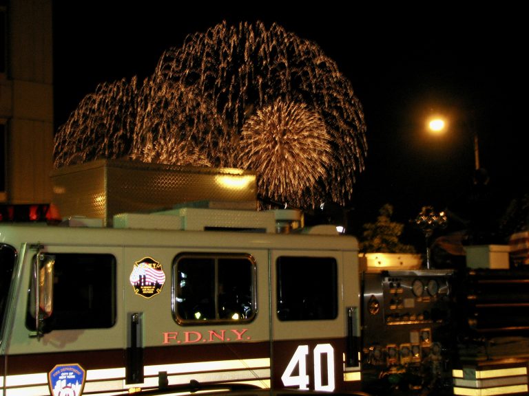 Golden cascading fireworks burst above an FDNY fire truck during the Macy's 4th of July Fireworks show along the Hudson River, 2009.