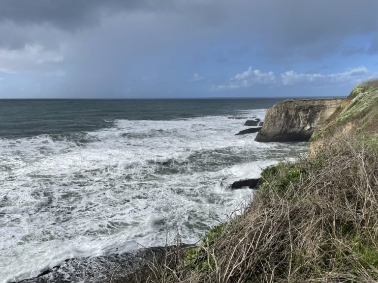 Shark Fin Rock framed by the broken coastline