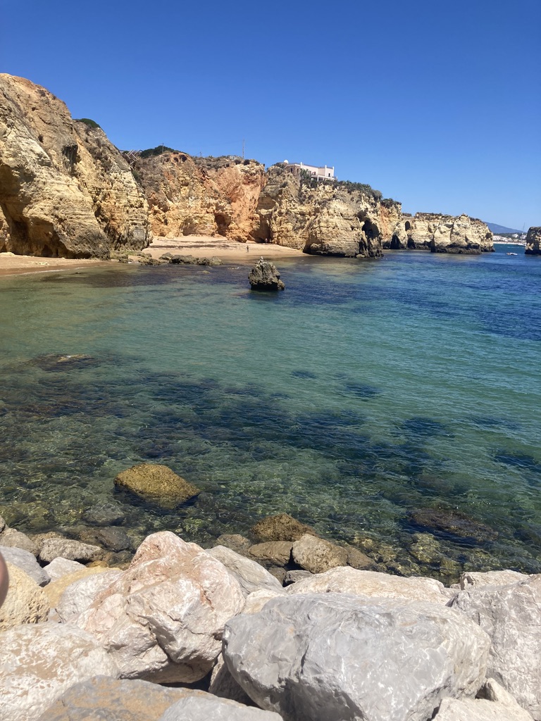 A quiet cove framed by sandstone cliffs