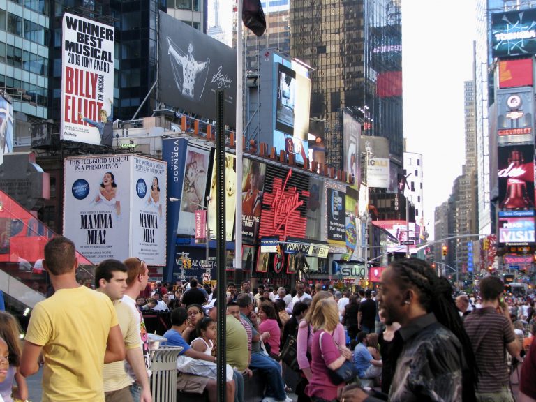 Times Square buzzes with July 4th holiday crowds beneath billboards for Billy Elliot — 2009 Tony Award Winner for Best Musical — and Mamma Mia!, New York City, 2009.