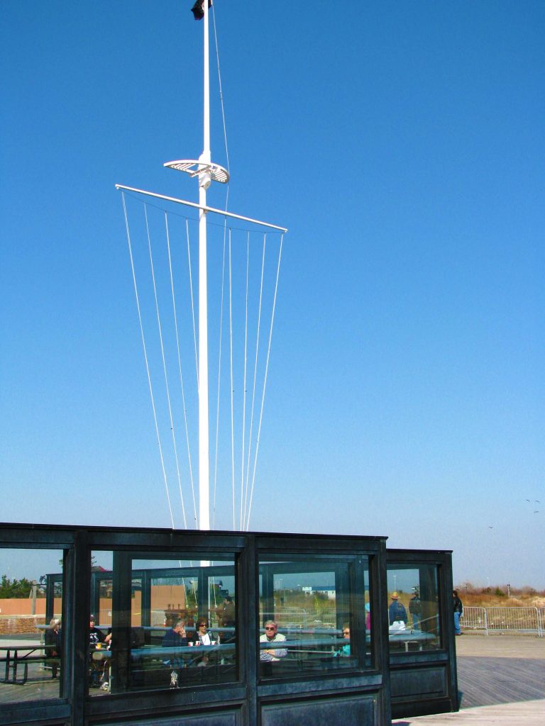 Mast and stays radiating against a deep blue sky.
