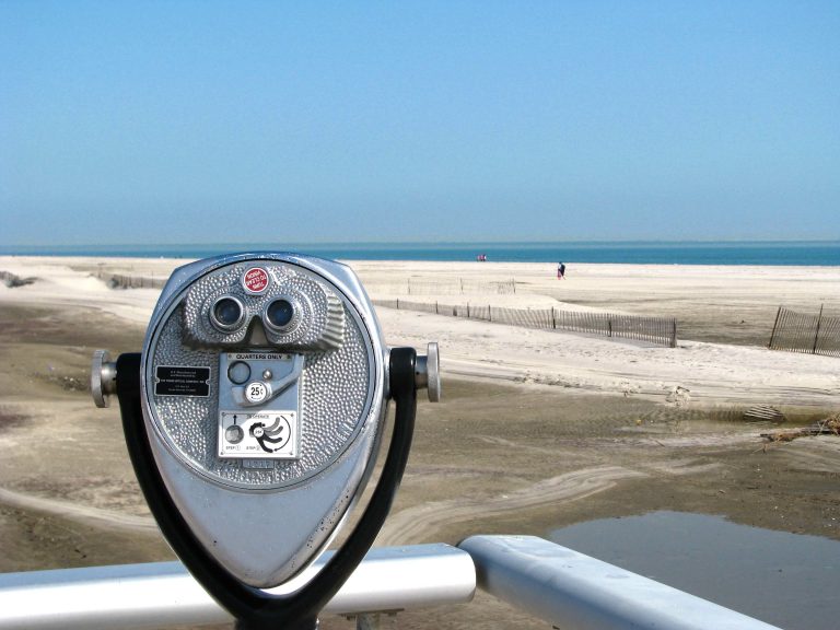 Coin-operated viewer pointed across the winter sea at Jones Beach.