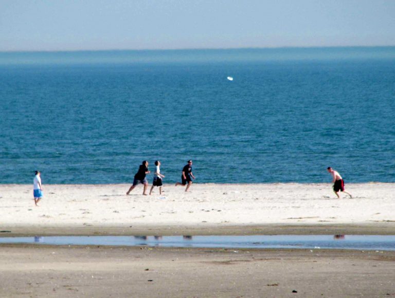 A pickup game of catch on the off-season sand at Jones Beach.