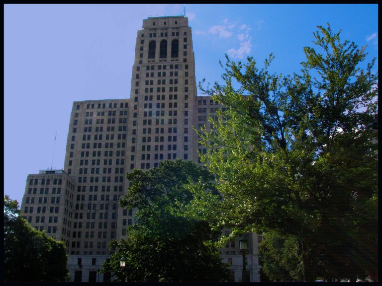 The Alfred E. Smith State Office Building towers above the trees in downtown Albany.