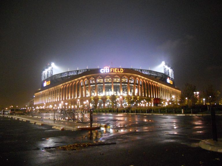 Citi Field glows against the night sky in Flushing, Queens. Home to the New York Mets, the stadium is a landmark of the NYC sports scene.