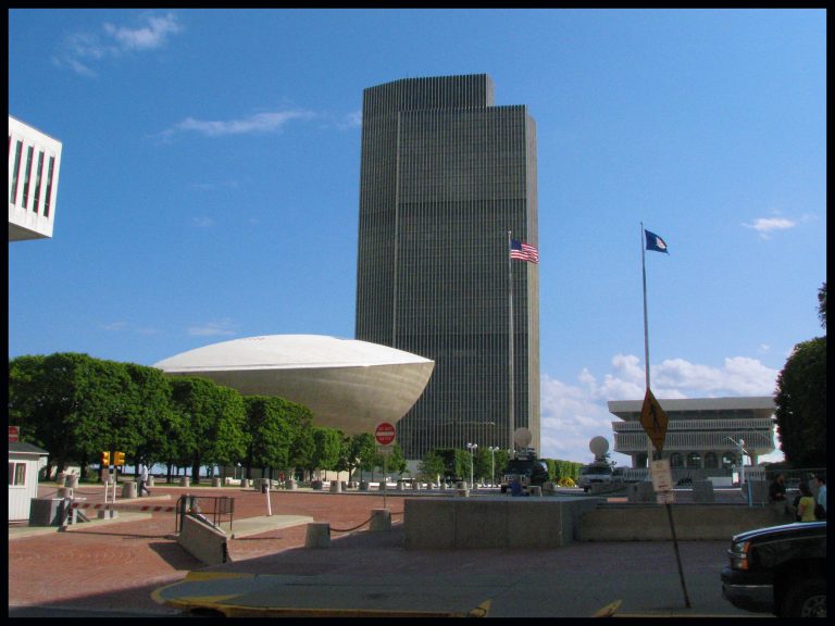 A view across Empire State Plaza with the distinctive saucer-shaped Egg performing arts center and a state office tower.