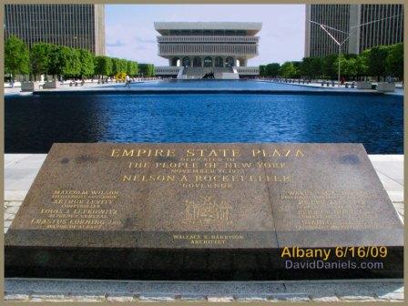 The Empire State Plaza dedication marker overlooks the reflecting pool that anchors the entrance to the complex.