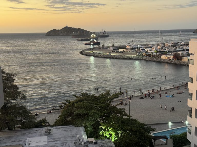 Locals gather at the Santa Marta waterfront at sunset