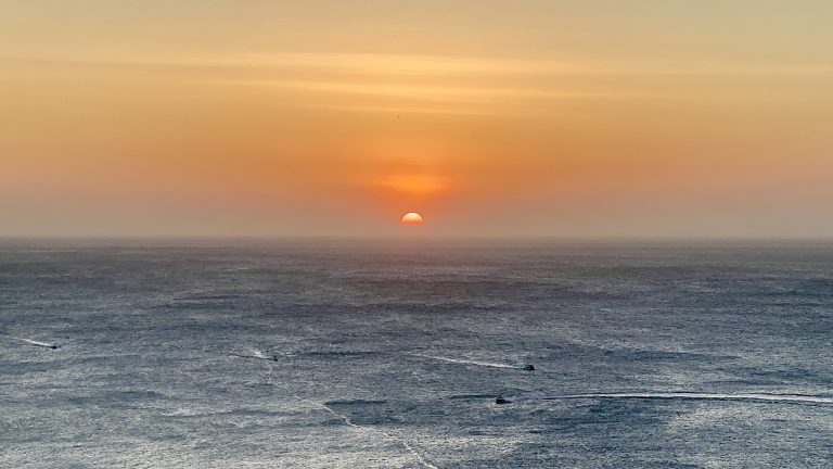 The sun disappearing into the Caribbean Sea