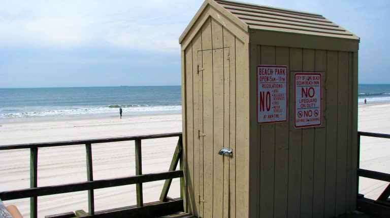 City of Long Beach Beach Park regulations posted on a boardwalk hut.