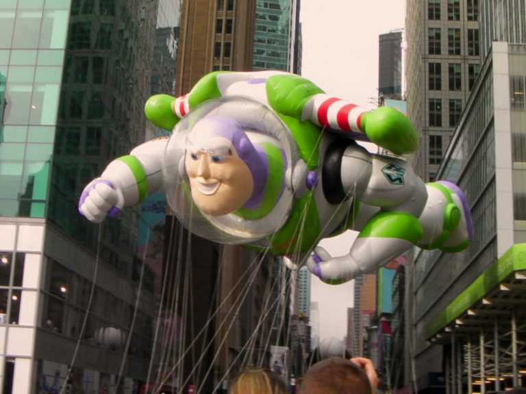 Buzz Lightyear soars between Midtown skyscrapers — Macy's Thanksgiving Day Parade, New York City, 2009.