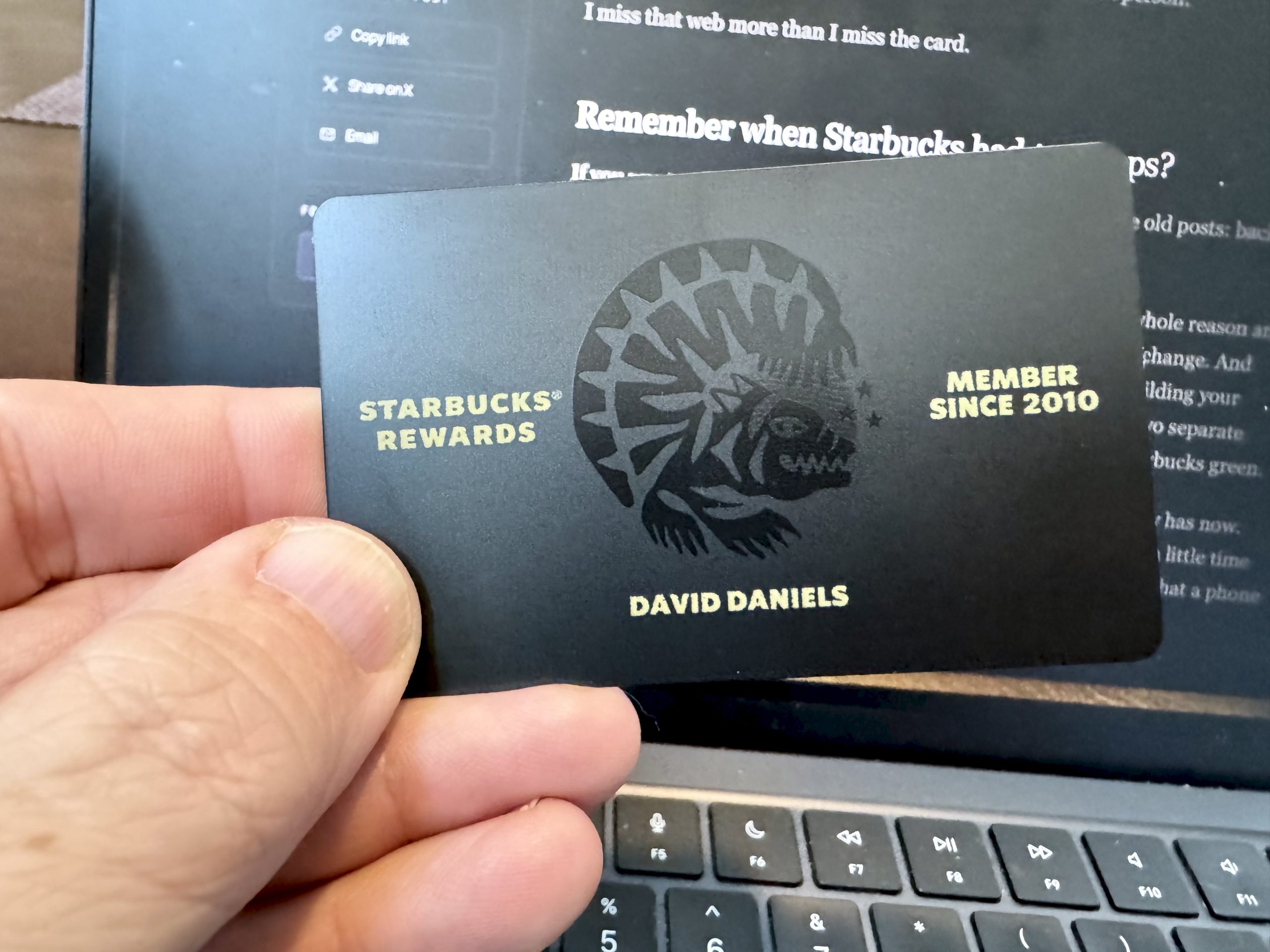 Black matte metal Starbucks Rewards Reserve card engraved with David Daniels, Member Since 2010